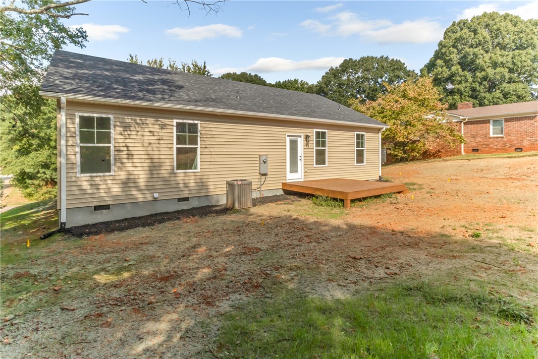 1115 Marshall Road Anderson, SC 29626 - Photo 31 of 35 A wooden deck steps down to the grassy backyard from the rear of the home.