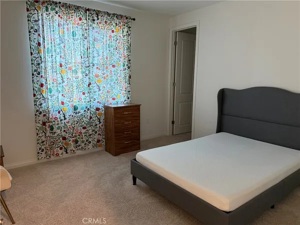 a bedroom with a bed and a wall painting