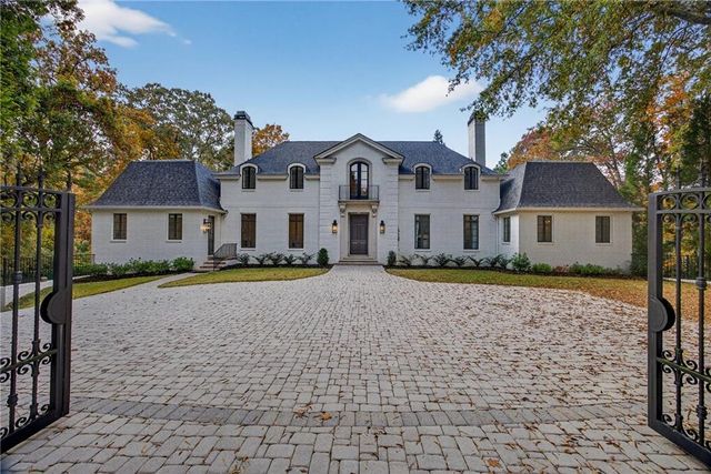 a house that has a tree in front of it