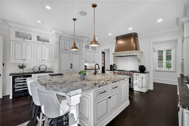 a open kitchen with white cabinets and stainless steel appliances