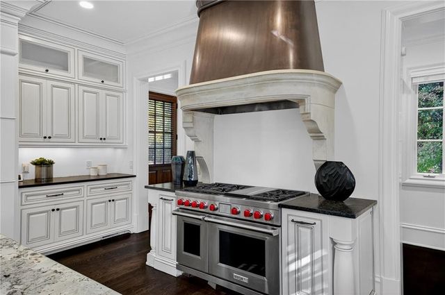 a view of a living room hardwood floor and a large window
