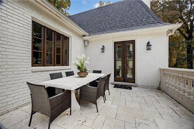 an empty room with wooden floor cabinet and windows