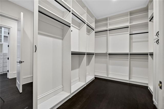 a bathroom with a granite countertop sink mirror bathtub and next to a window