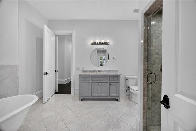 a view of entryway door with potted plants and brick walls