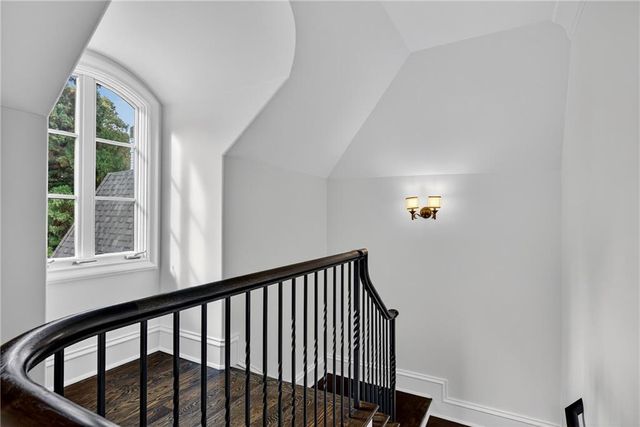 a view of an empty room with a fireplace and a window