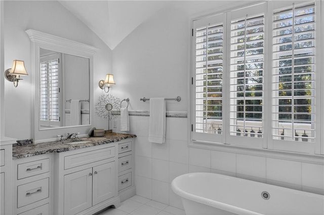 a view of a house with pool and chairs