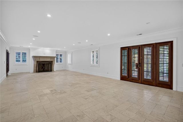 an aerial view of a house with a yard and large trees