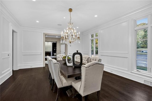 a living room with furniture and large windows