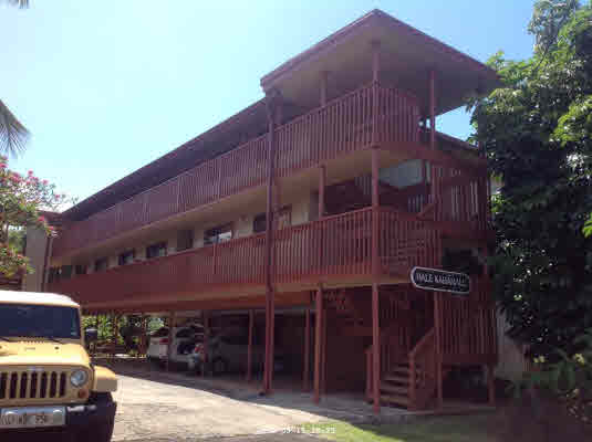 2240 Kuai Road, Unit 7 Koloa, HI 96756 - Photo 1 of 1 a front view of a building with glass windows and a fire pit