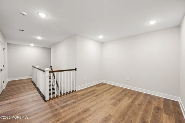 a view of hallway with wooden floor