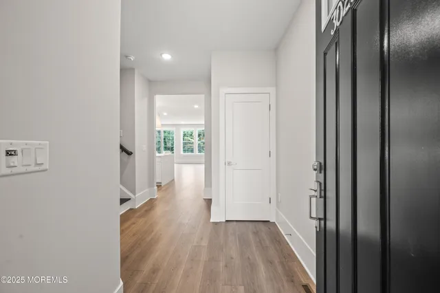 a view of a hallway with wooden floor