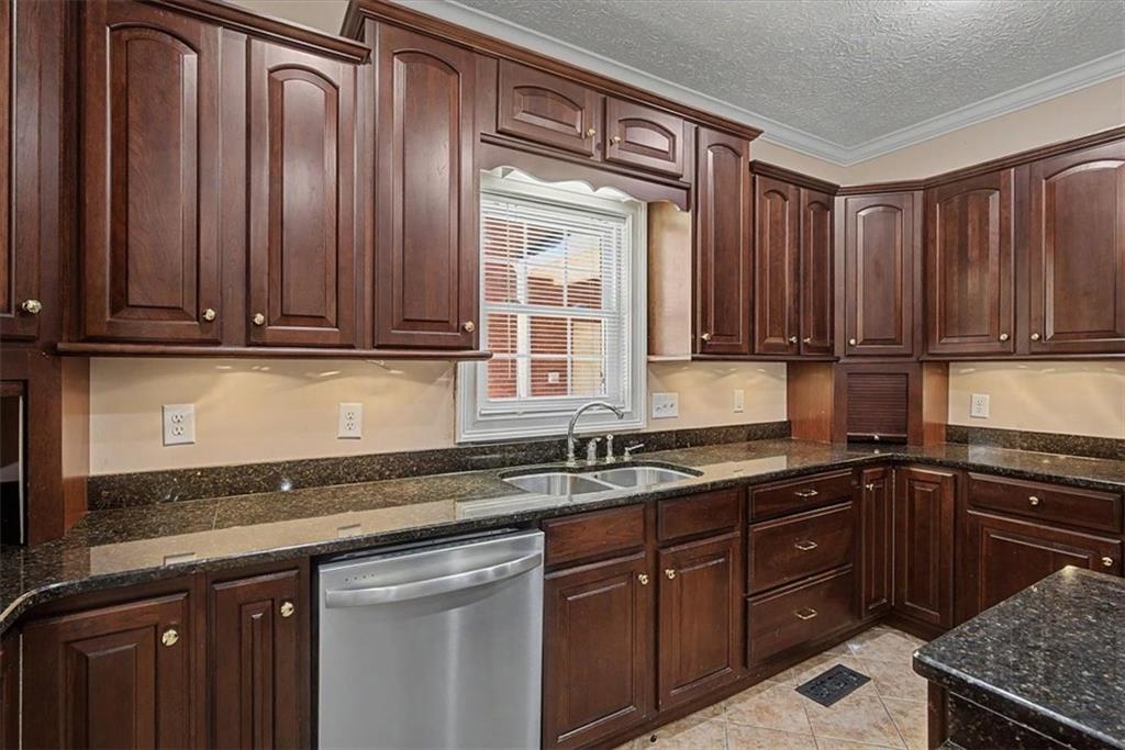 1136 Cole Lake Road Dallas, GA 30157 - Photo 21 of 72 a kitchen with granite countertop a sink a stove and cabinets