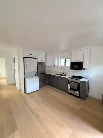 a room view with wooden floor and window
