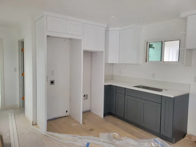 a kitchen with cabinets and window
