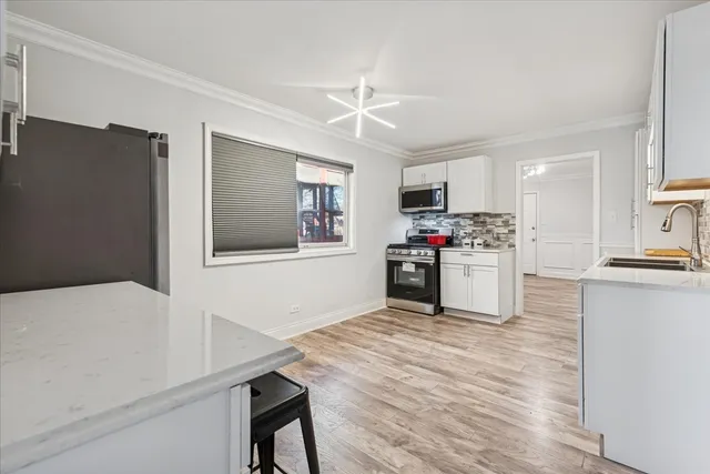 a kitchen with microwave a stove and refrigerator