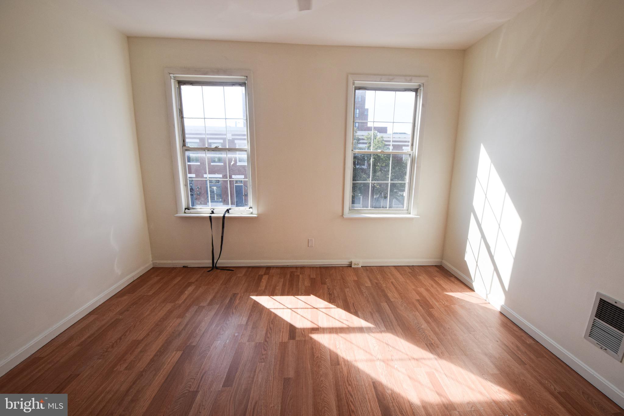 3606 Hudson Street Baltimore, MD 21224 - Photo 19 of 52 an empty room with wooden floor and windows