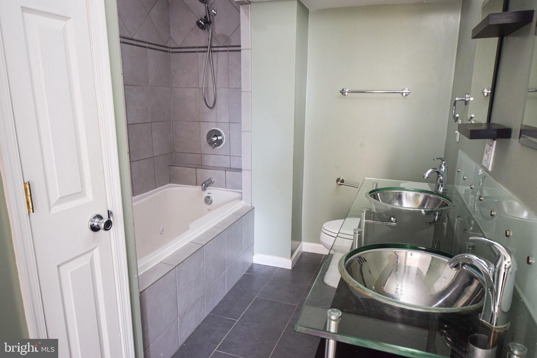 3606 Hudson Street Baltimore, MD 21224 - Photo 23 of 52 a bathroom with a sink a toilet and shower