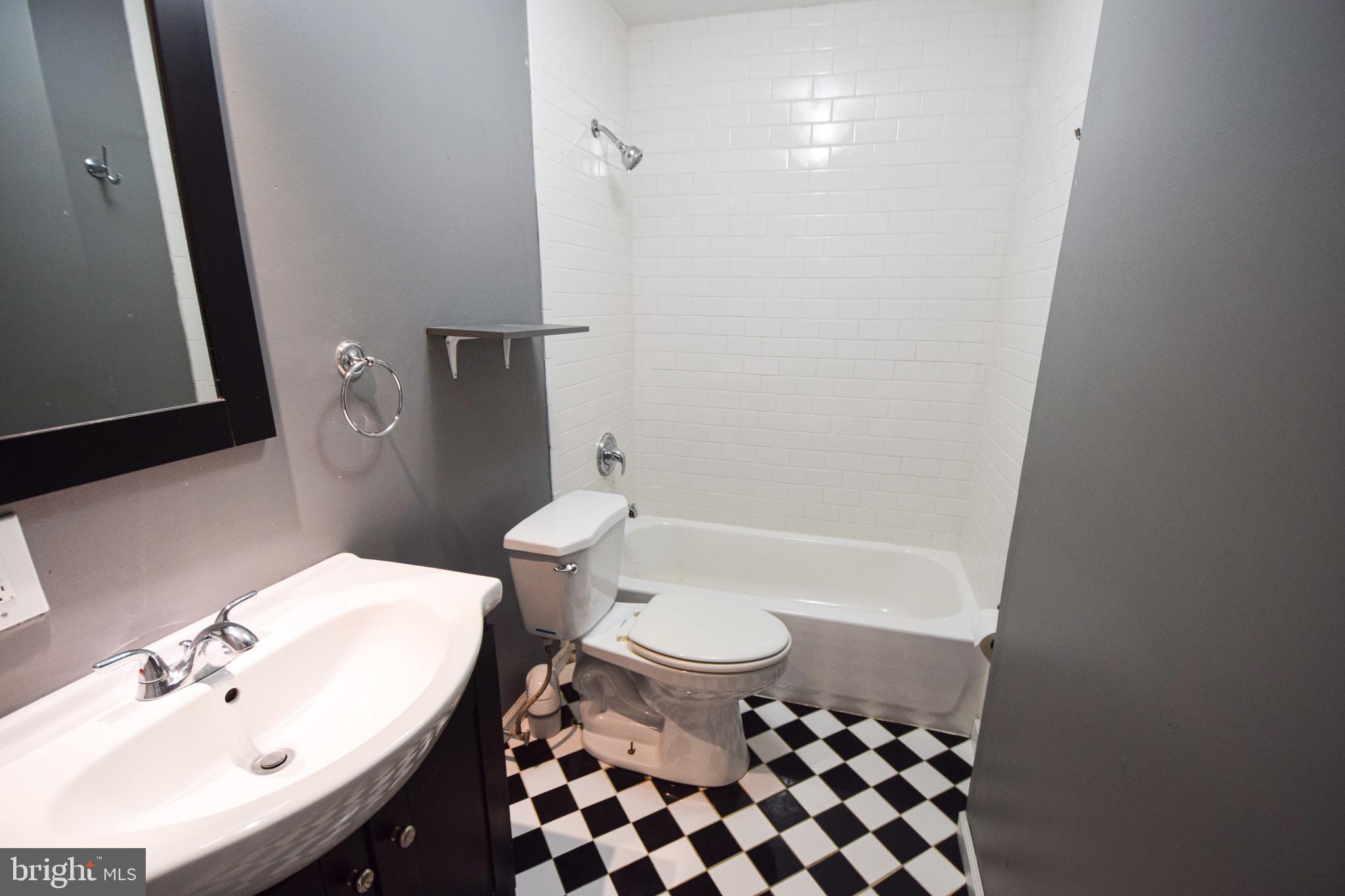 3606 Hudson Street Baltimore, MD 21224 - Photo 33 of 52 a bathroom with a sink toilet and shower