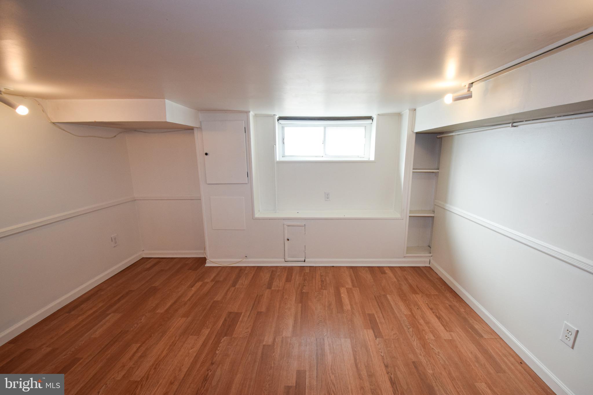 3606 Hudson Street Baltimore, MD 21224 - Photo 36 of 52 an empty room with wooden floor and windows