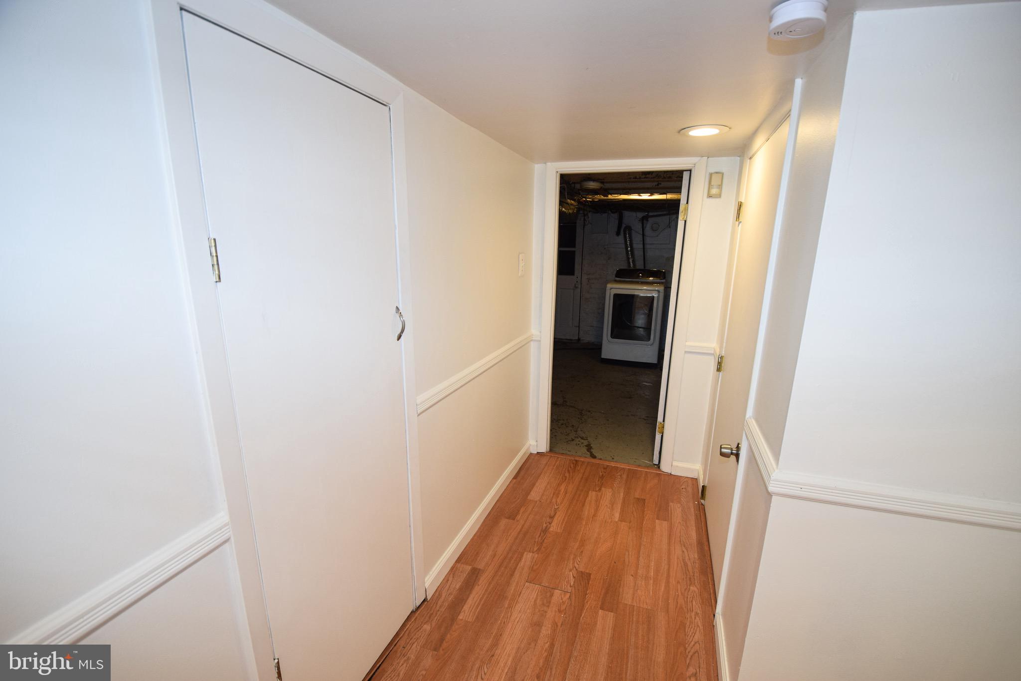 3606 Hudson Street Baltimore, MD 21224 - Photo 38 of 52 a view of a hallway with wooden floor and closet