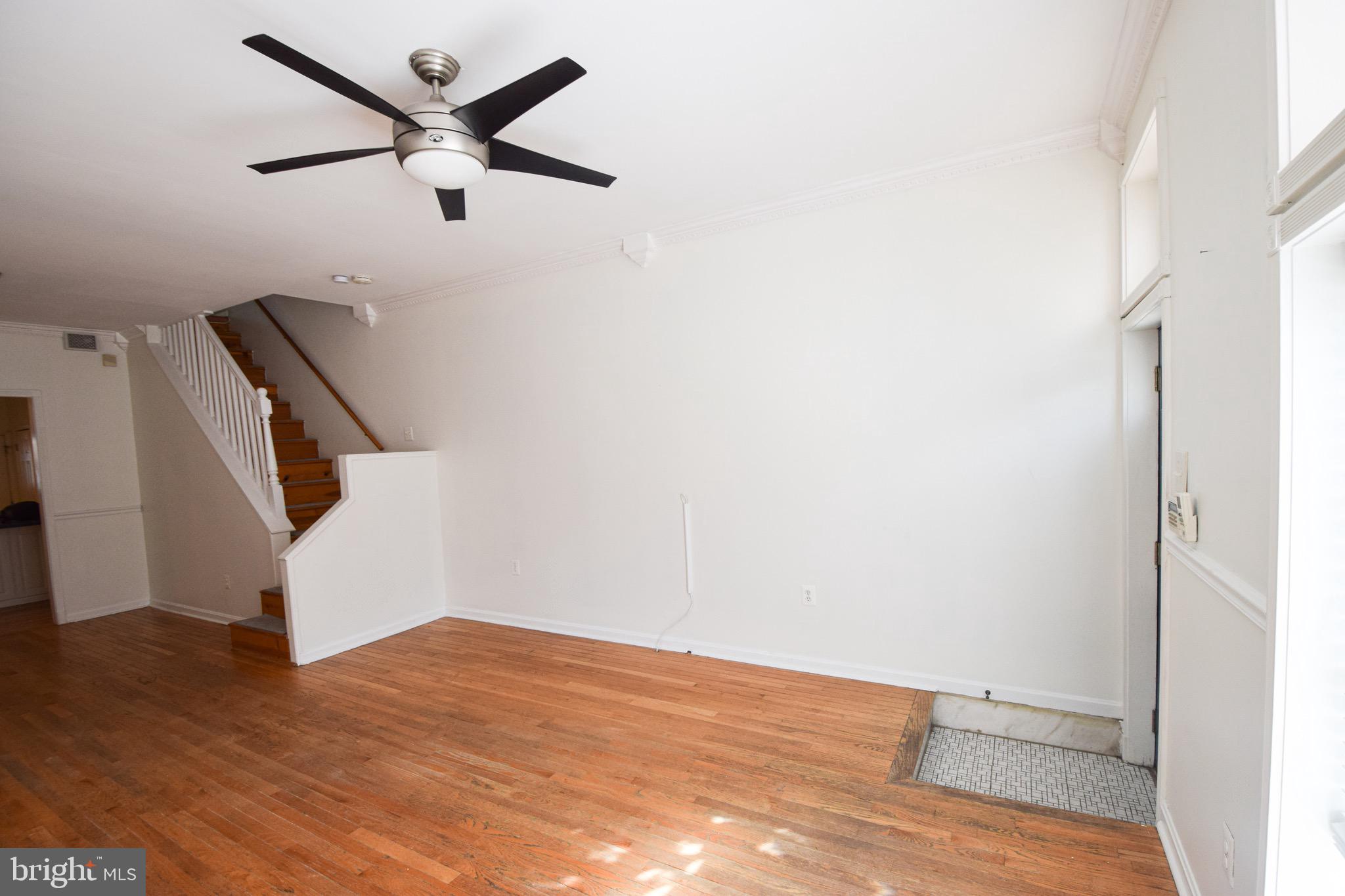 3606 Hudson Street Baltimore, MD 21224 - Photo 5 of 52 an empty room with wooden floor and white walls