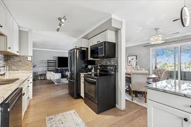 a kitchen with kitchen island a sink stove and refrigerator