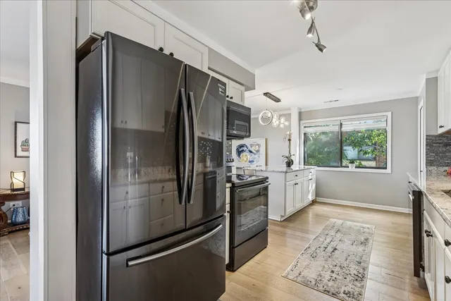 a kitchen with stainless steel appliances a refrigerator and a stove