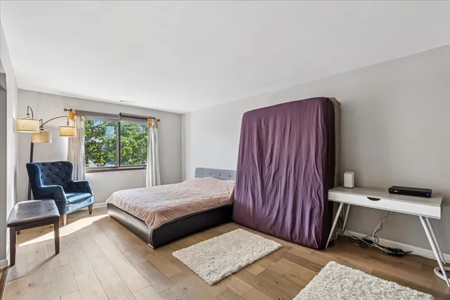 a living room with a bed furniture and a window