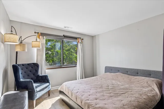 a bedroom with a bed couch and window