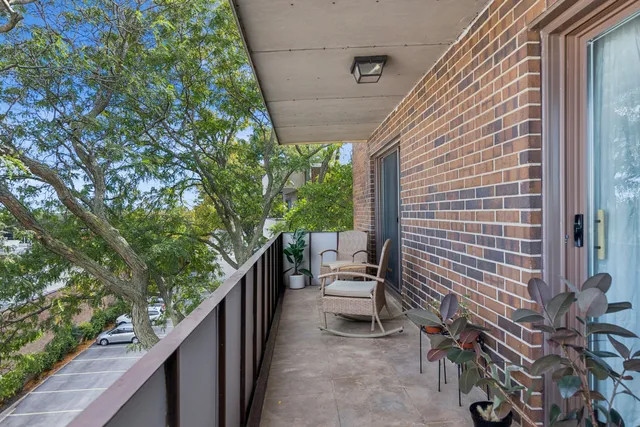 a view of a balcony with chairs