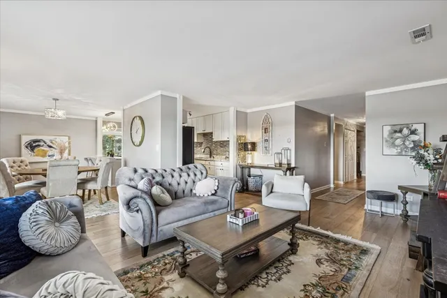 a living room with furniture rug and wooden floor