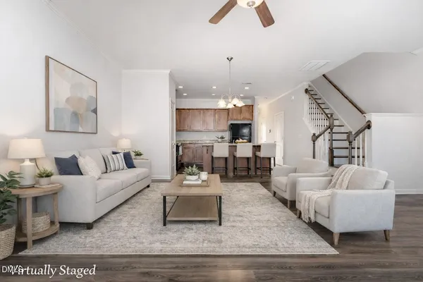 a living room with furniture and kitchen view