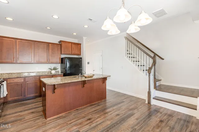 a view of kitchen and hall with wooden floor