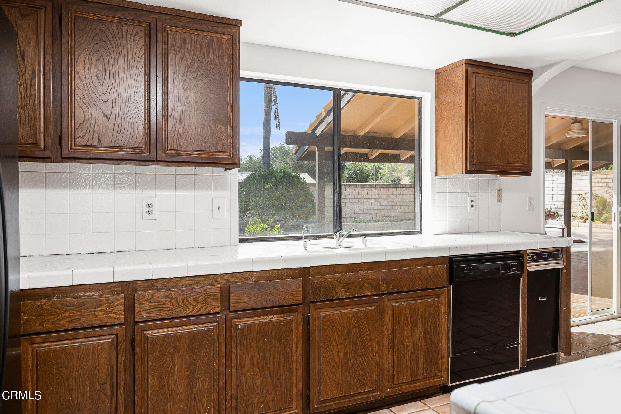 1006 Amber Drive Santa Paula, CA 93060 - Photo 16 of 37 a kitchen with stainless steel appliances granite countertop wooden cabinets a sink and dishwasher