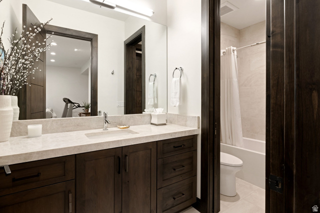 11547 Soaring Hawk Lane Hideout, UT 84036 - Photo 18 of 43 Bathroom featuring a large vanity with a light-toned countertop, integrated rectangular sink, dark wood-finish cabinetry with black hardware, and a framed mirror with overhead lighting