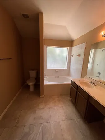 a bathroom with a sink a toilet and tub