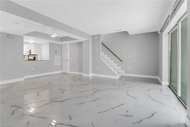 an empty space with white walls and stairs