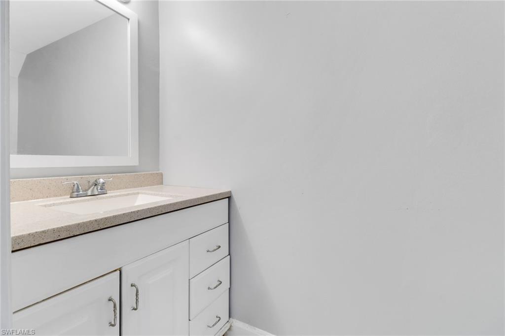 15 Watercolor Way, Unit 15 Naples, FL 34113 - Photo 14 of 29 a bathroom with a sink and a mirror