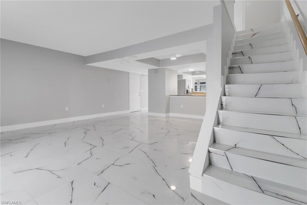 15 Watercolor Way, Unit 15 Naples, FL 34113 - Photo 15 of 29 a view of an empty room with stairs and white walls