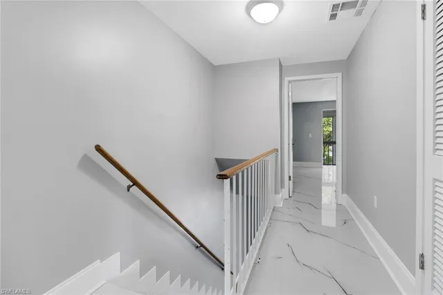 a view of a hallway with wooden floor and entryway