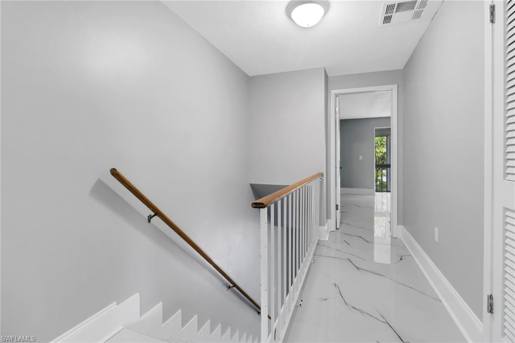 15 Watercolor Way, Unit 15 Naples, FL 34113 - Photo 16 of 29 a view of a hallway with wooden floor and entryway