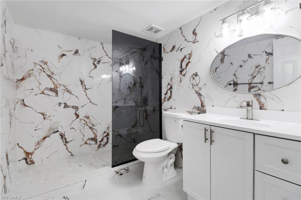 15 Watercolor Way, Unit 15 Naples, FL 34113 - Photo 19 of 29 a bathroom with a sink toilet and shower