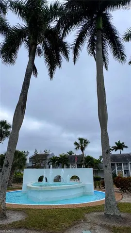 a view of a house with a small yard and a garden
