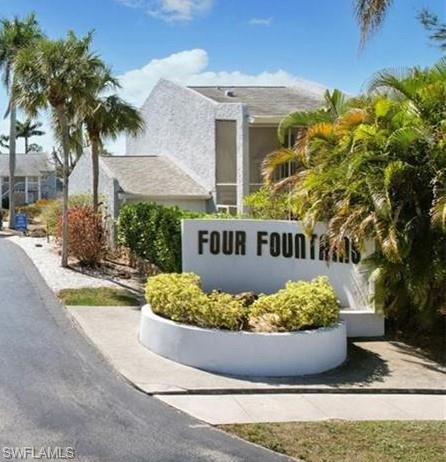 15 Watercolor Way, Unit 15 Naples, FL 34113 - Photo 29 of 29 a view of a house with a small yard and a garden