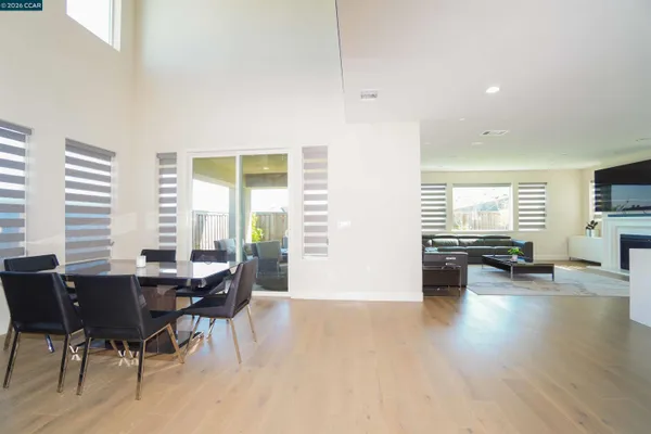 a living room with furniture a flat screen tv and a window