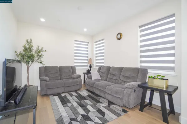 a view of a hallway with wooden floor and windows