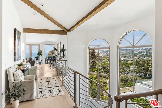 a view of a dining room with furniture and a potted plant
