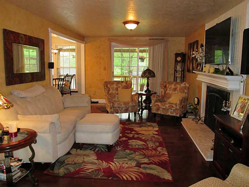 6938 Mellon Road Export, PA 15632 - Photo 9 of 24 Family Room. VIEW OF WOOD BURNING FIREPLACE AND OPEN FLOOR PLAN INTO KITCHEN