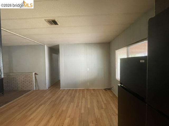 16629 Allison Way, Unit 4 Sonora, CA 95370 - Photo 15 of 25 an empty room with wooden floor and windows