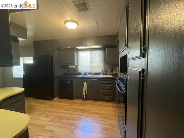 16629 Allison Way, Unit 4 Sonora, CA 95370 - Photo 9 of 25 a kitchen with stainless steel appliances granite countertop a refrigerator and a sink